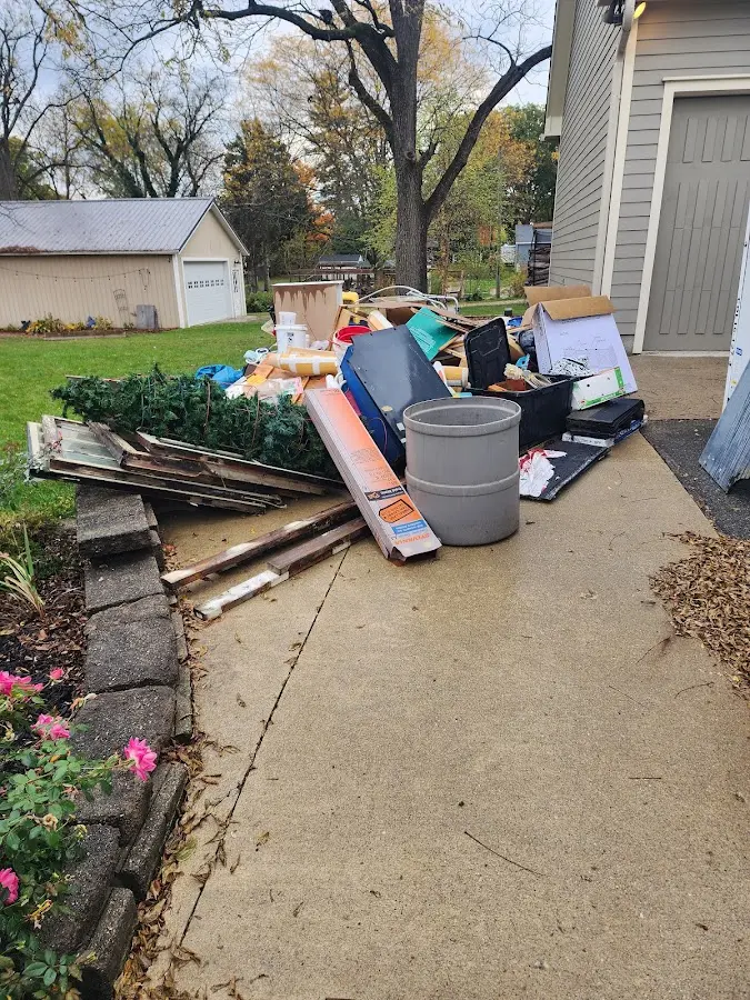 Dumpster being loaded with debris for 12 Yard Dumpster Rental in Oregon
